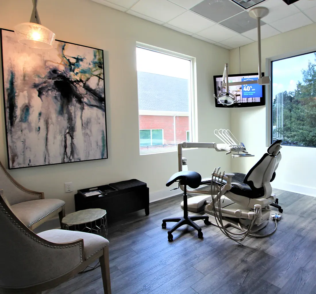 Modern dental treatment room at Atlanta Dental Spa's East Cobb office, featuring a comfortable dental chair, advanced equipment, and stylish décor for a relaxing patient experience.